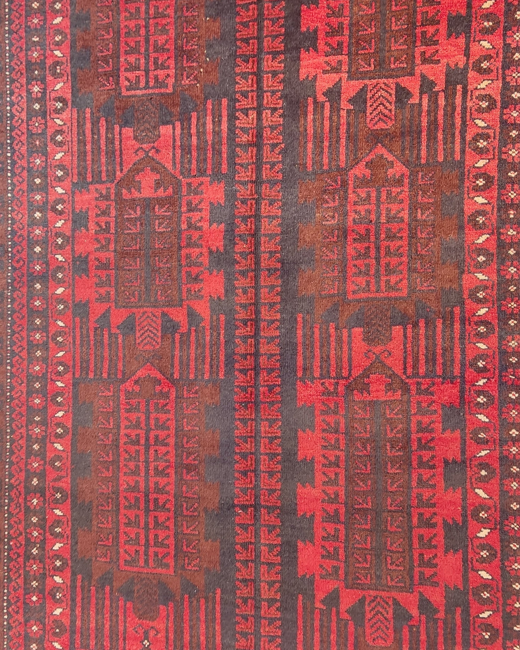 Tappeto Beluch persiano annodato a mano con motivi geometrici tribali nei toni del rosso e bordeaux, misura 200x125 cm