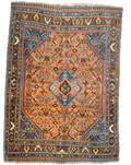 Tappeto Qashqai persiano annodato a mano con medaglione centrale azzurro e motivi tribali su fondo terracotta, misura 162x112 cm
