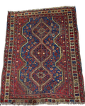 Tappeto persiano Shiraz usato 140x110 cm annodato a mano con tre medaglioni geometrici nei toni del rosso e blu